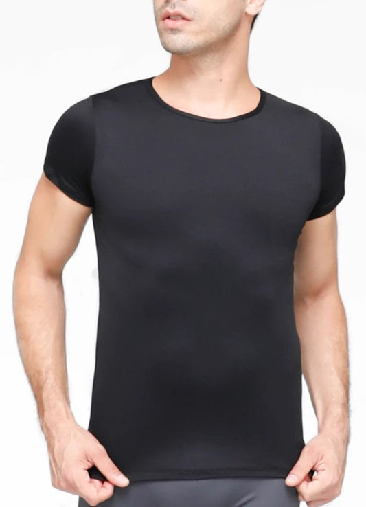 Dancer is wearing a black short-sleeve snug-fit dance shirt. He has paired it with grey tights and has his hands on his hips.