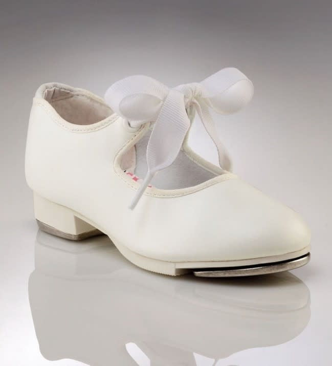 A Mary Jane style, white, synthetic leather tap shoe. Features include, foam cushioned insole, cloth ribbon ties for closure, and an achilles notch and padded collar for comfort.