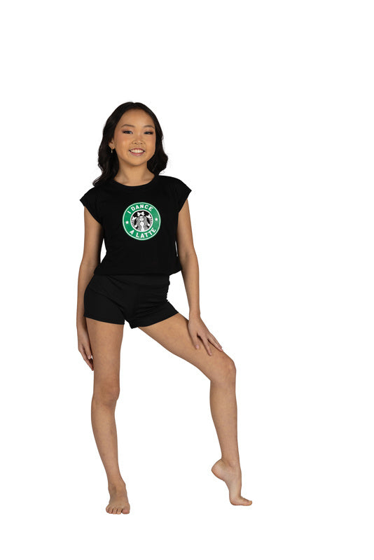 Dancer is wearing a black, crew neck, short sleeve, cropped t-shirt with " I Dance A Latte" screen print on the front. She has paired the shirt with black shorts and is standing with her left knee bent and left hand on her thigh.