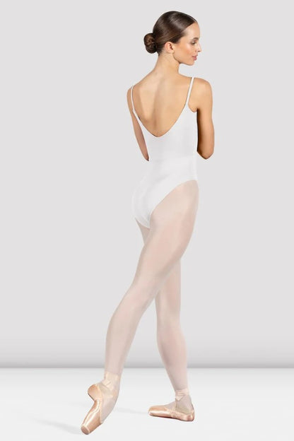 Dancer is wearing a white, camisole leotard with a scoop neck and back and bodice seam detail. She has paired the garment with pink tights and pointe shoes. Dancer is standing with her right foot pointed back and is showing a back angle of the leotard.