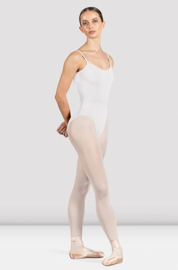 Dancer is wearing a white, camisole leotard with a scoop neck and back and bodice seam detail. She has paired the garment with pink tights and pointe shoes and is standing in a fourth position with her hands behind her back.