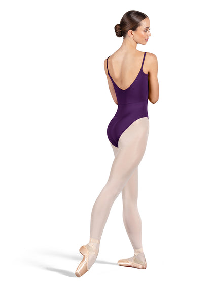 Dancer is wearing an aubergine, camisole leotard with a scoop neck and back and bodice seam detail. She has paired the garment with pink tights and pointe shoes. Dancer is standing with her right foot pointed back and is showing a back angle of the leotard.