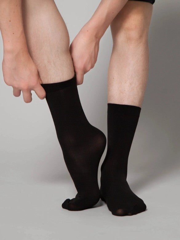 Dancer is wearing a pair of lightweight black dance socks.