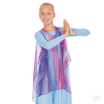 Dancer is wearing a loose fit, sparkle tulle  tunic featuring a soft swirl of pastel colors, flat metallic sequins, a slightly gathered neckline and open sides. Dancer has paired the garment with a light blue, long sleeve dress.