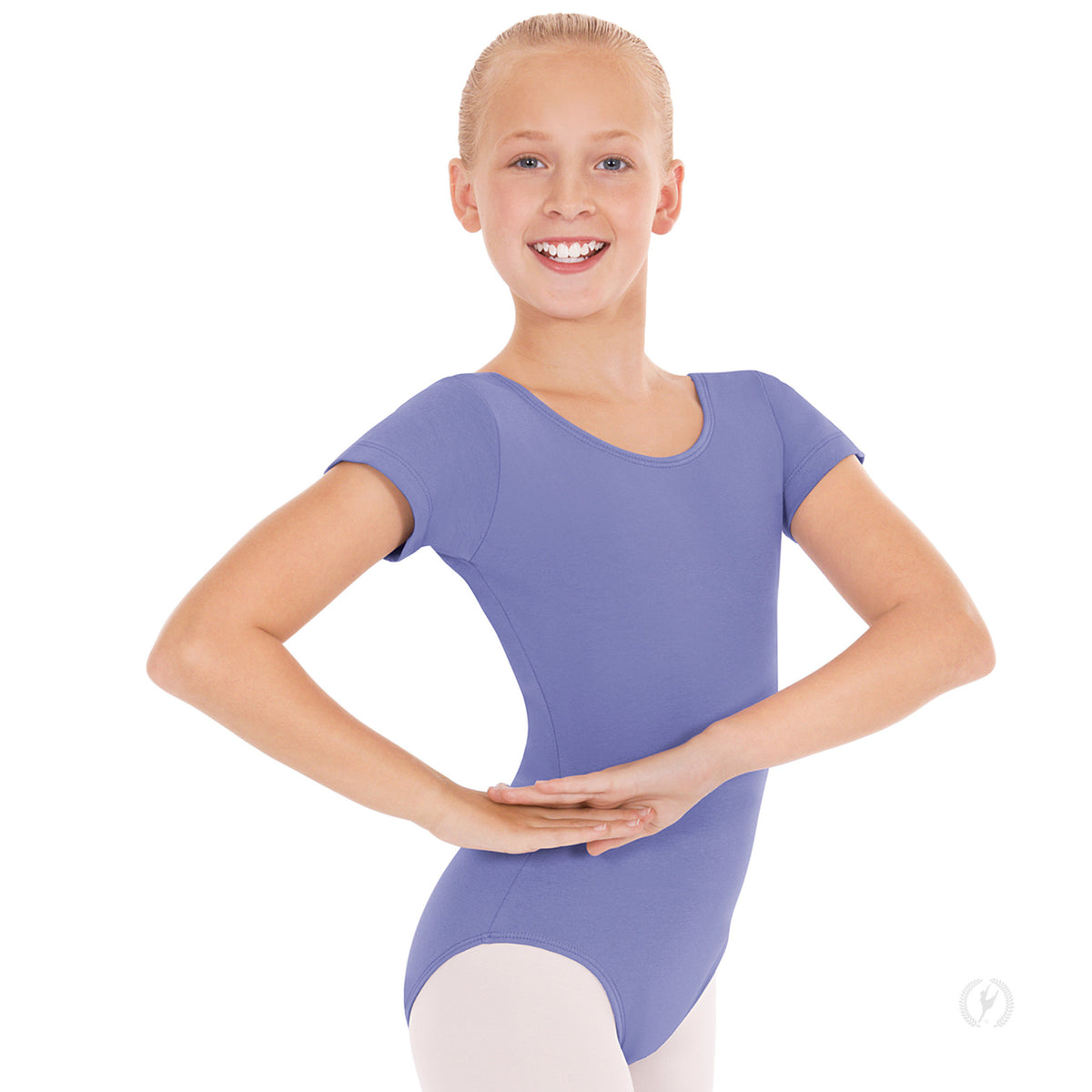 Dancer is wearing a lilac, short sleeve, scoop neck and back leotard. She is also wearing pink tights and has her hands at her right hip.