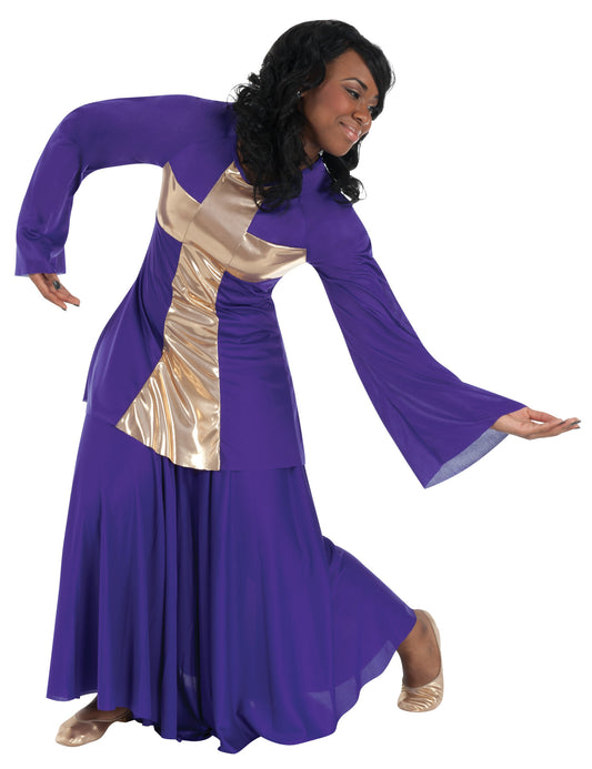 Dancer is wearing a purple, pullover shirt with long semi bell sleeves, a generously flared bodice and a front sewn-in gold metallic cross. Dancer has paired the top with a long purple skirt.